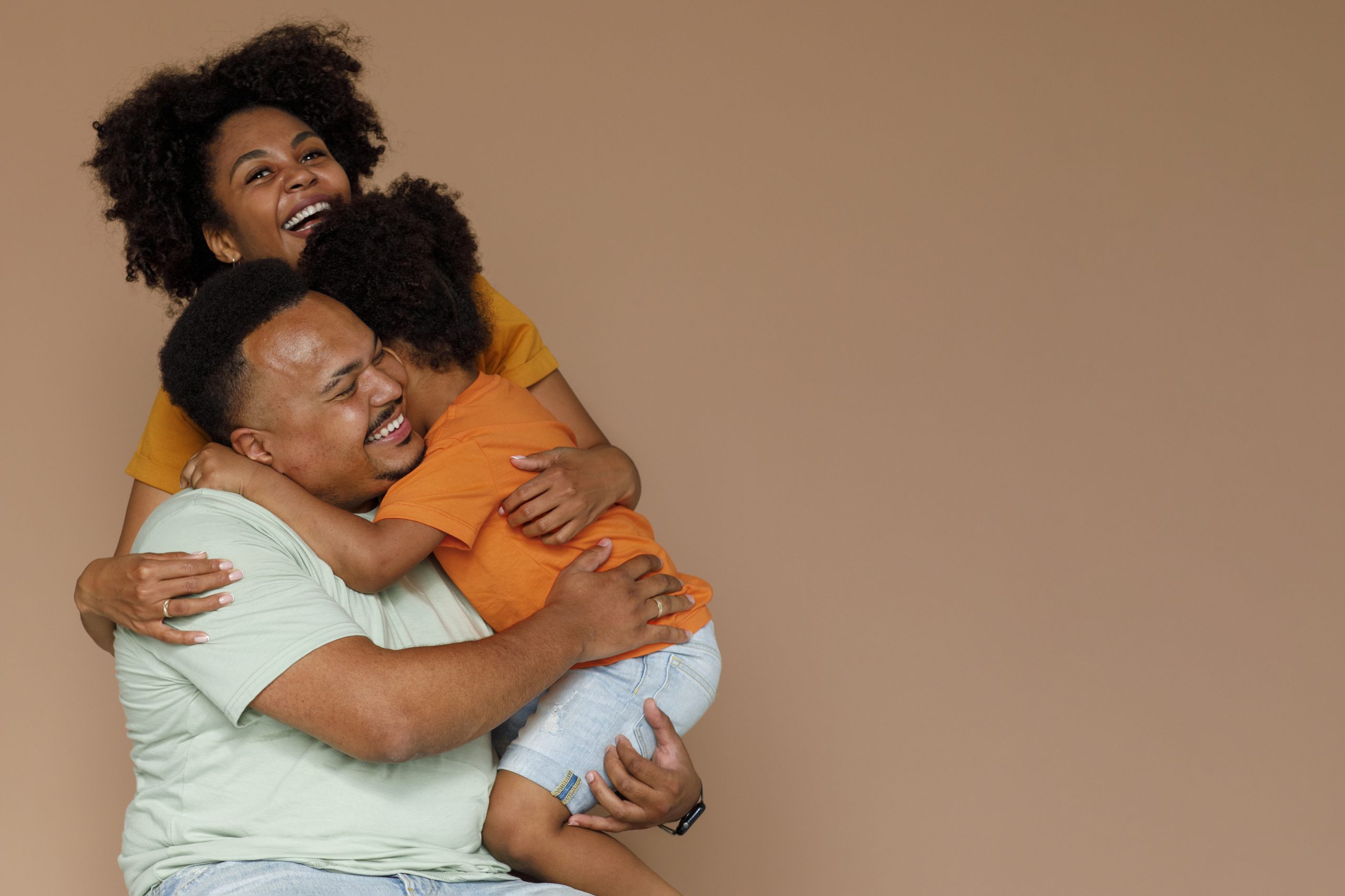 medium-shot-black-family-posing-studio